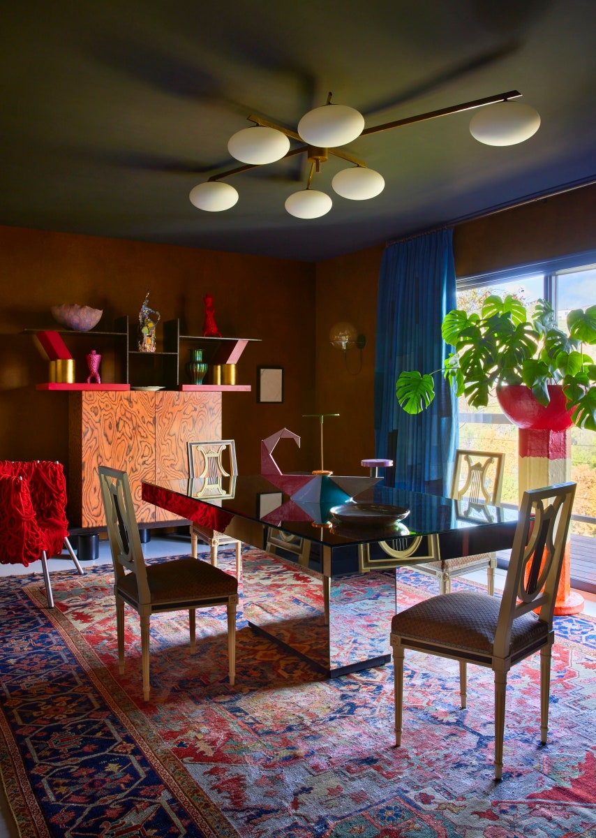 Mirrored surfaces and chrome furniture are on the upswing for 2024. Here a mirrored dining table anchors a dining room...