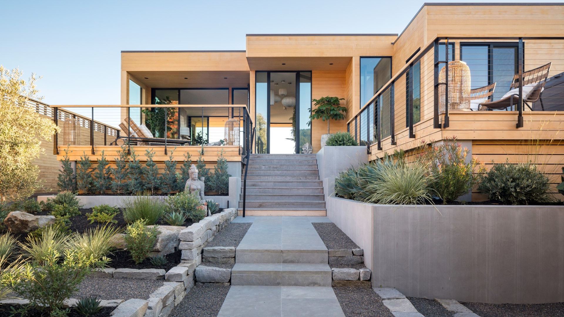 A beachside property that Skornicka Designs  Construction Inc. refreshed incorporates rows of greenery outside natural...